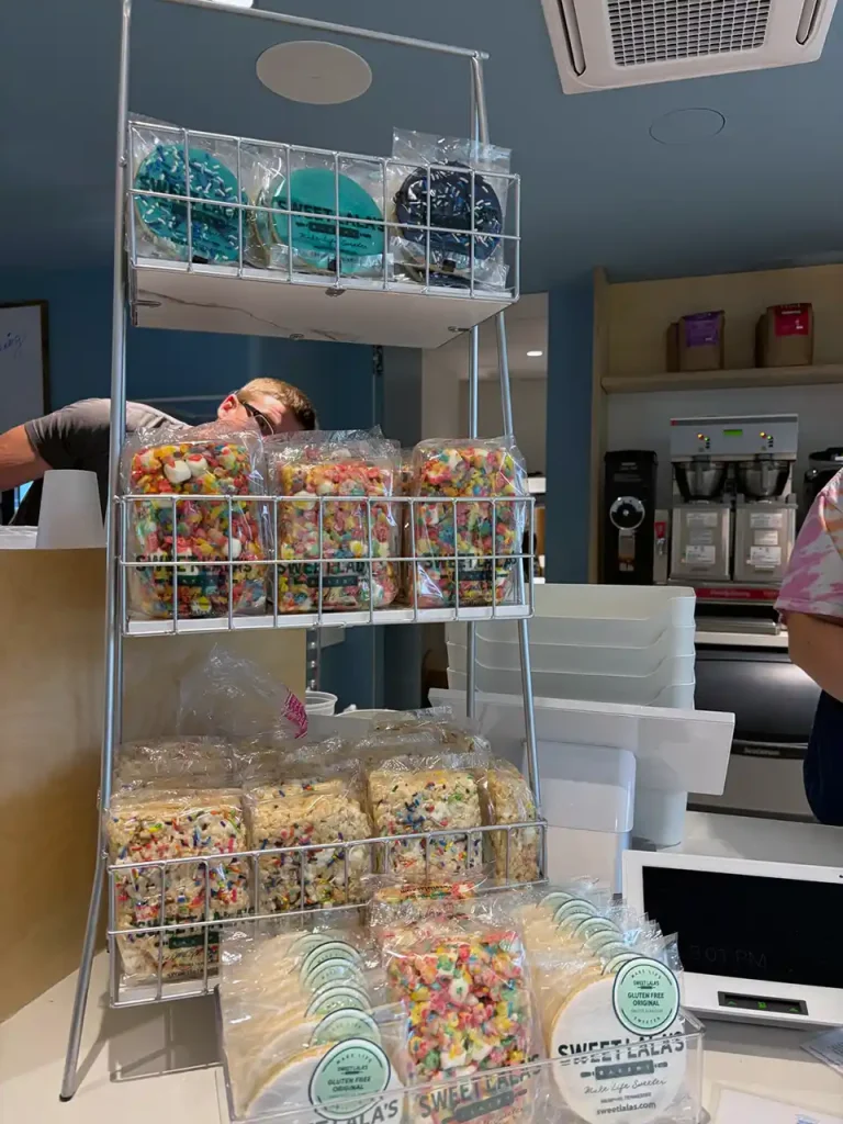 Countertop display shelves filled with Sweet LaLa's Bakery treats at Second Helpings Café