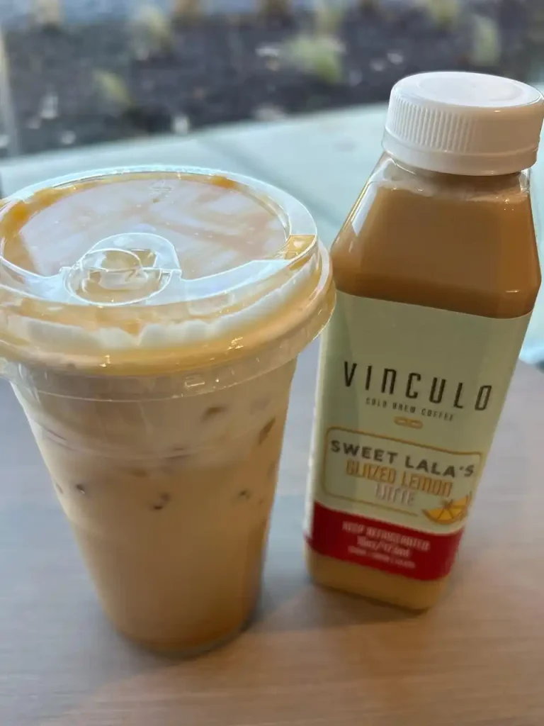 Bottle of Vinculo Glazed Lemon Latte next to a cup at Second Helpings Café Memphis