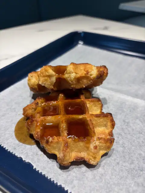 Belgian waffles with maple syrup served fresh at Second Helpings Café for breakfast